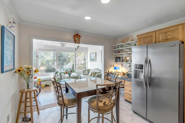 dining room with ceiling fan and ornamental molding