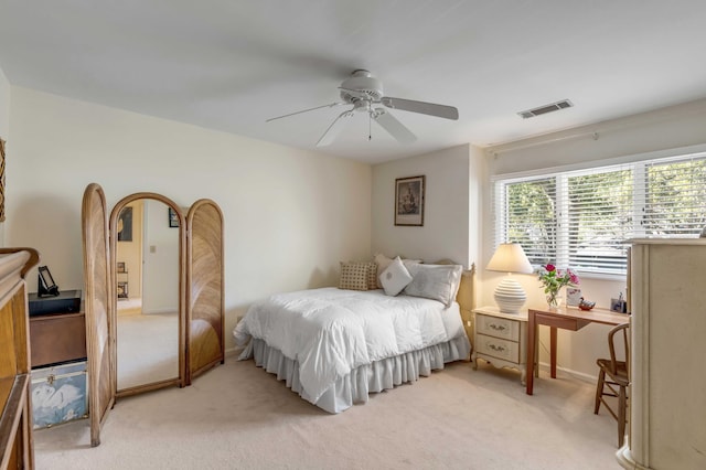 bedroom with ceiling fan and light carpet