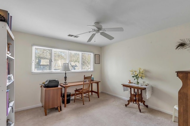 home office with ceiling fan and light carpet