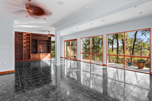 unfurnished living room with ceiling fan