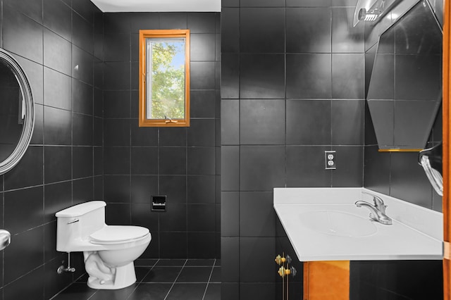 bathroom featuring sink, tile patterned flooring, tile walls, and toilet