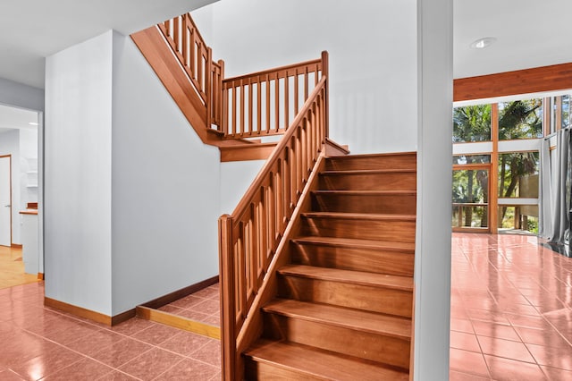 stairway with tile patterned floors