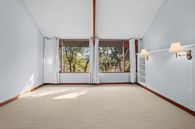 empty room featuring carpet flooring and lofted ceiling