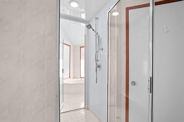 bathroom with tile patterned flooring, independent shower and bath, and vaulted ceiling