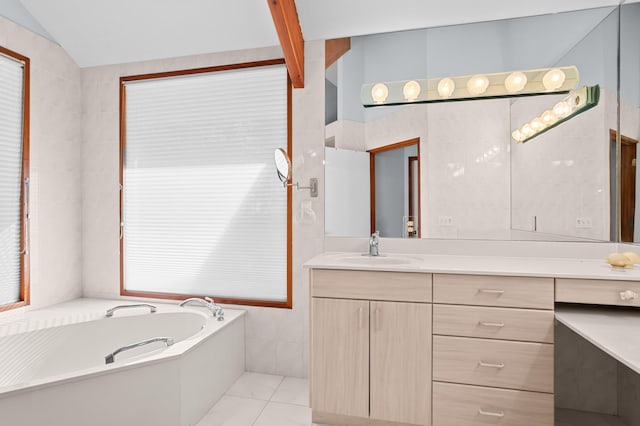 bathroom with a washtub, tile patterned floors, lofted ceiling, vanity, and tile walls