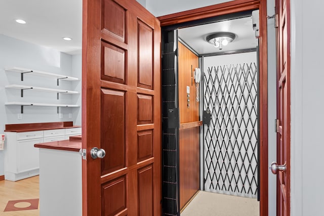 interior space with wood-type flooring and elevator