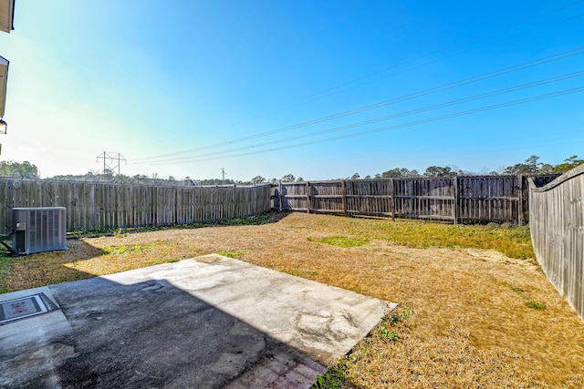 view of yard featuring a patio and central air condition unit