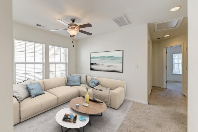 living room with ceiling fan and light colored carpet