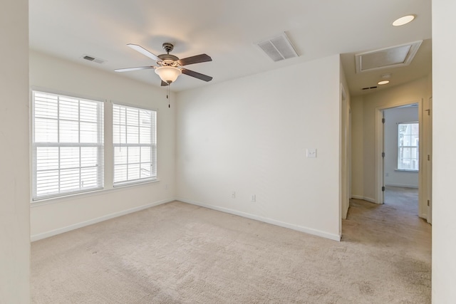 carpeted spare room featuring ceiling fan