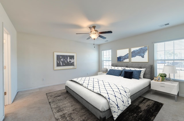 bedroom featuring light colored carpet and ceiling fan