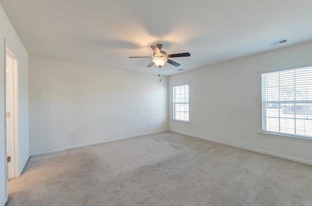 unfurnished room featuring ceiling fan and light carpet