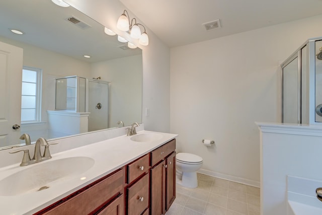 bathroom featuring vanity, toilet, tile patterned floors, and a shower with shower door