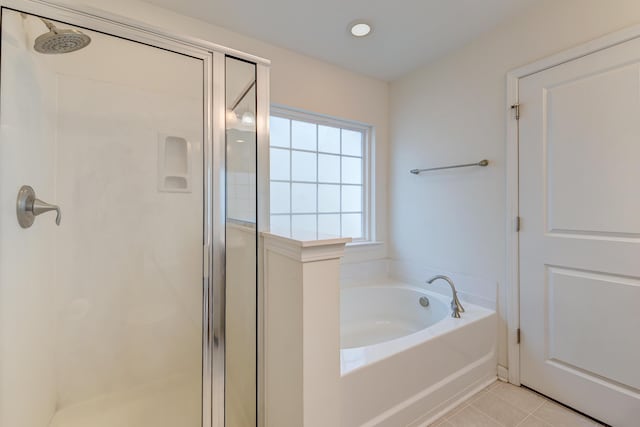 bathroom with independent shower and bath and tile patterned floors