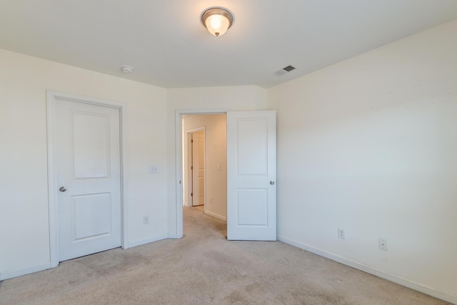 unfurnished bedroom featuring light colored carpet