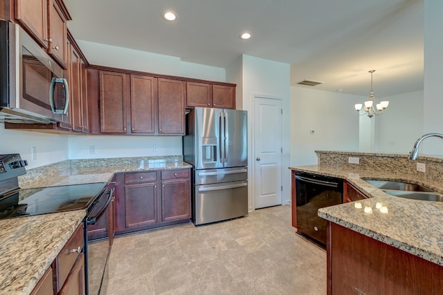 kitchen with appliances with stainless steel finishes, sink, hanging light fixtures, light stone countertops, and an inviting chandelier