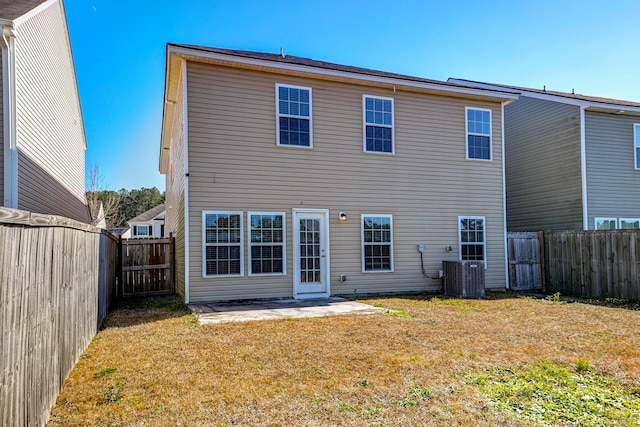 back of property with a yard, central AC, and a patio area