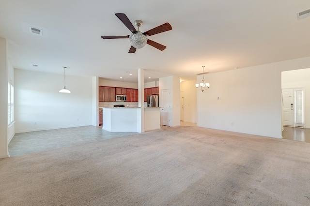 unfurnished living room with ceiling fan with notable chandelier and light carpet