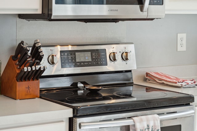 interior details featuring white cabinetry and appliances with stainless steel finishes