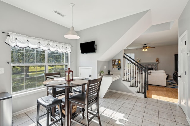 tiled dining space with ceiling fan