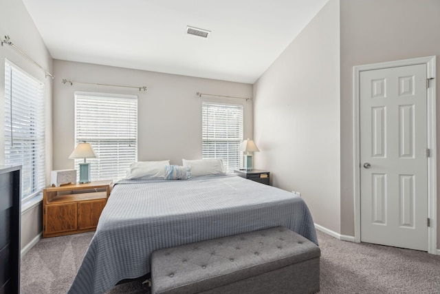 bedroom featuring lofted ceiling and light colored carpet