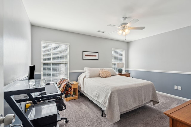 carpeted bedroom with multiple windows and ceiling fan