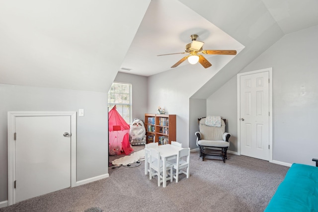 interior space with lofted ceiling, ceiling fan, and carpet