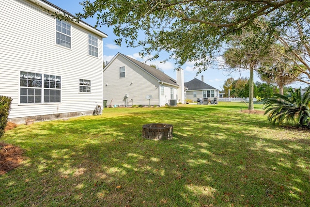 view of yard featuring cooling unit and an outdoor fire pit