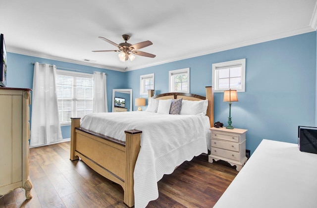 bedroom featuring crown molding, visible vents, dark wood finished floors, and ceiling fan