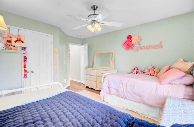 bedroom with ceiling fan, a closet, and wood finished floors