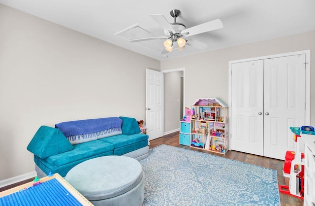 playroom featuring baseboards, attic access, a ceiling fan, and wood finished floors