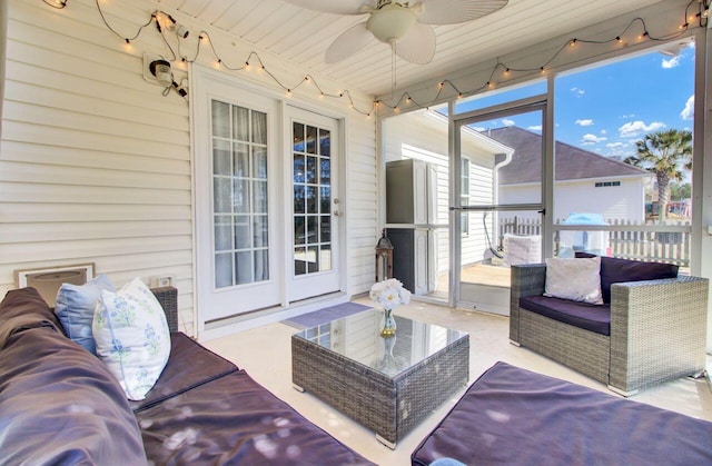 sunroom / solarium featuring a ceiling fan