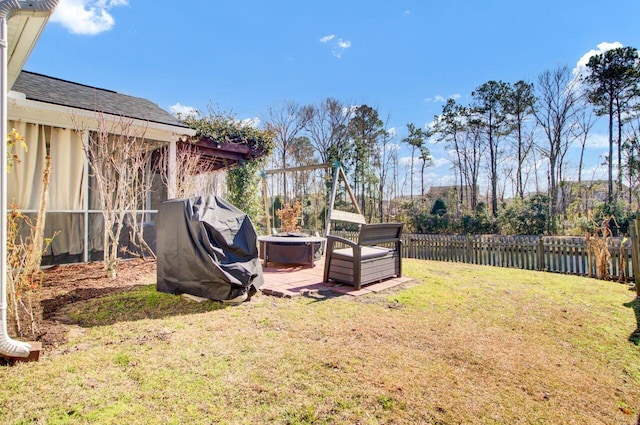 view of yard featuring a fire pit and fence