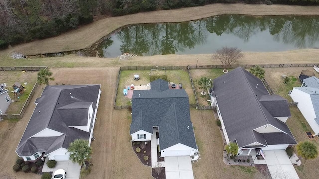 birds eye view of property with a water view