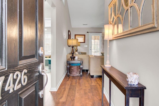 foyer entrance featuring wood finished floors and baseboards