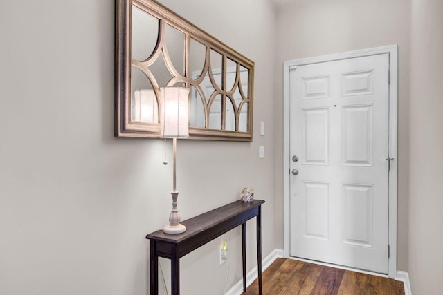 entryway featuring dark wood-type flooring and baseboards