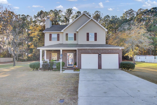 view of property featuring covered porch, a garage, and a front lawn