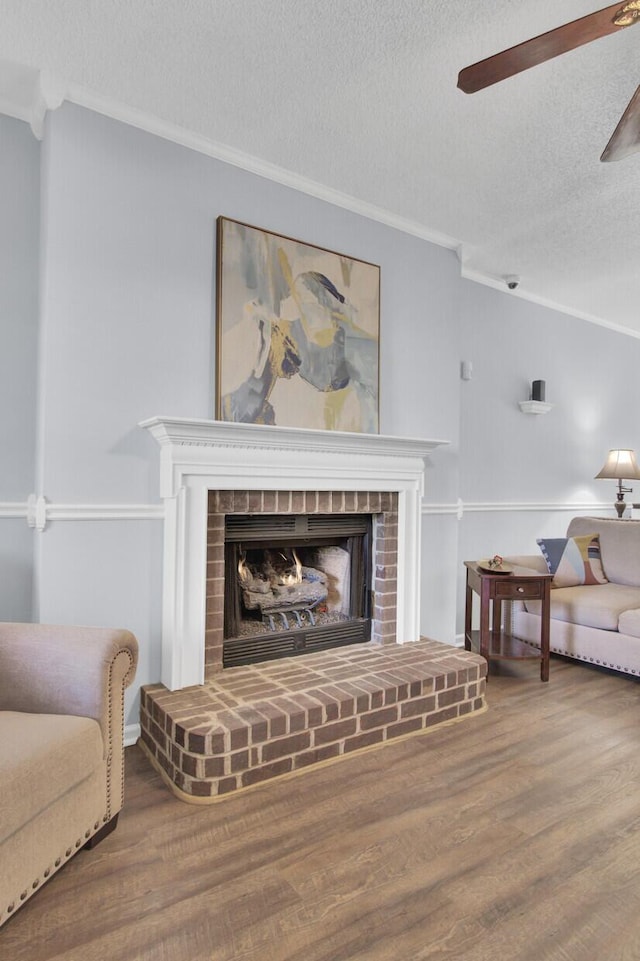 interior space featuring a fireplace, wood-type flooring, and ornamental molding