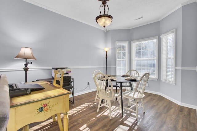 dining area featuring crown molding and dark wood-type flooring