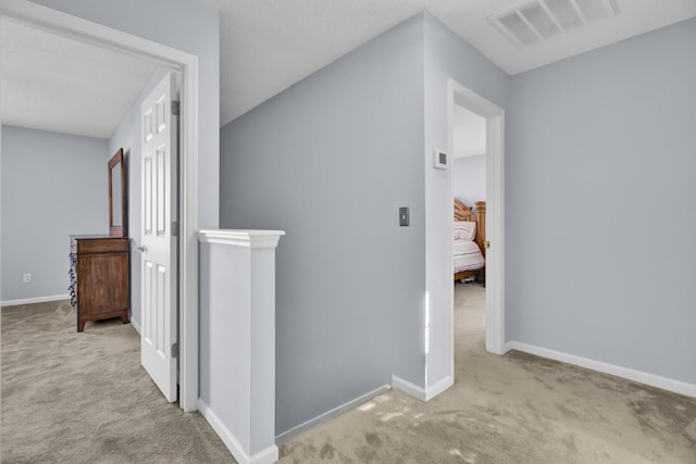 hallway with light carpet