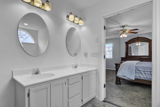 bathroom featuring ceiling fan, vanity, and a wealth of natural light