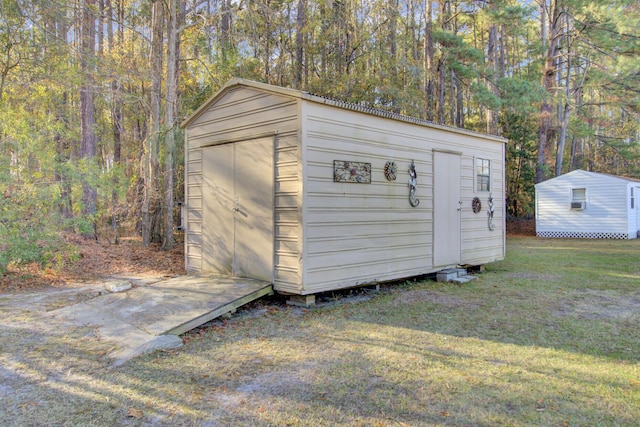 view of outbuilding with a yard