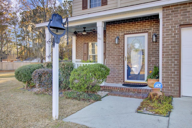 entrance to property with ceiling fan and covered porch