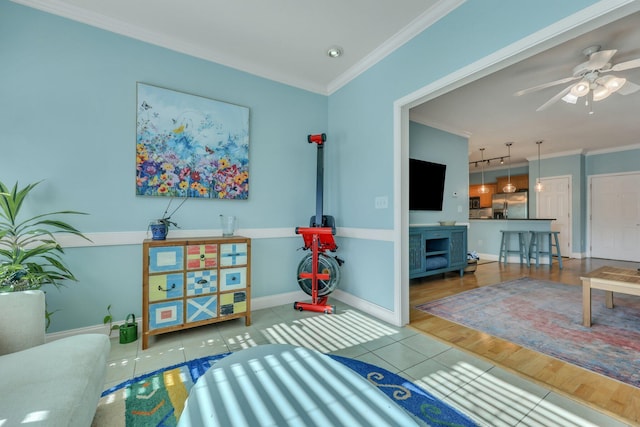 living room with tile patterned flooring, ceiling fan, and crown molding