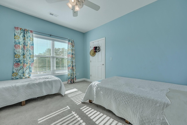 bedroom featuring ceiling fan and light carpet