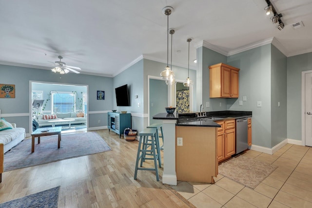 kitchen featuring ceiling fan, sink, stainless steel dishwasher, kitchen peninsula, and ornamental molding