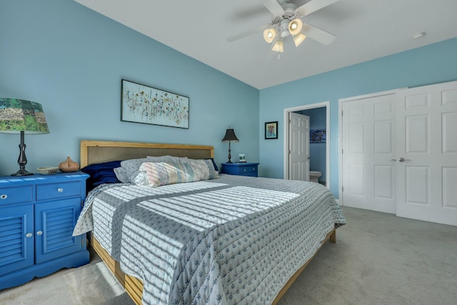 bedroom with ceiling fan, light carpet, and a closet