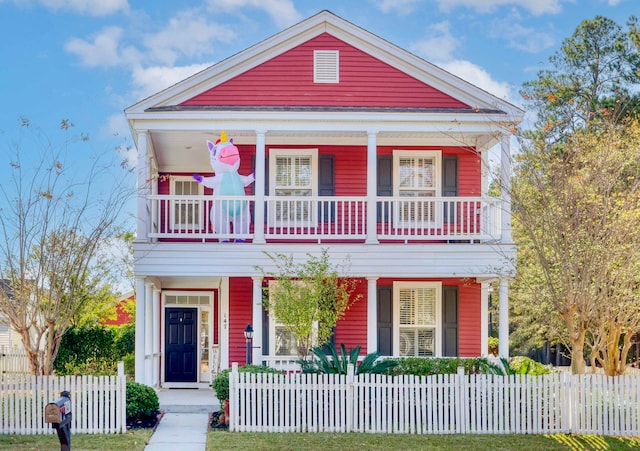 view of front of property featuring a balcony and a porch