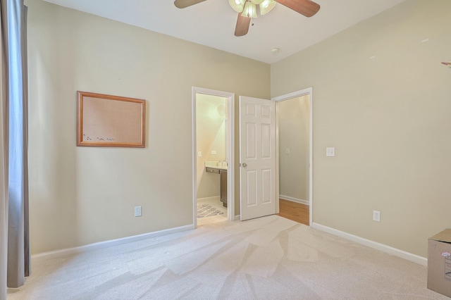 carpeted bedroom featuring ceiling fan and ensuite bathroom