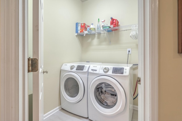 clothes washing area featuring separate washer and dryer