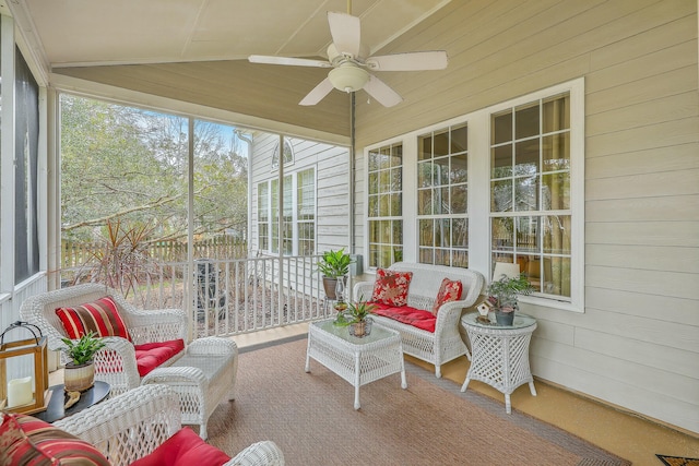 sunroom / solarium with ceiling fan and vaulted ceiling